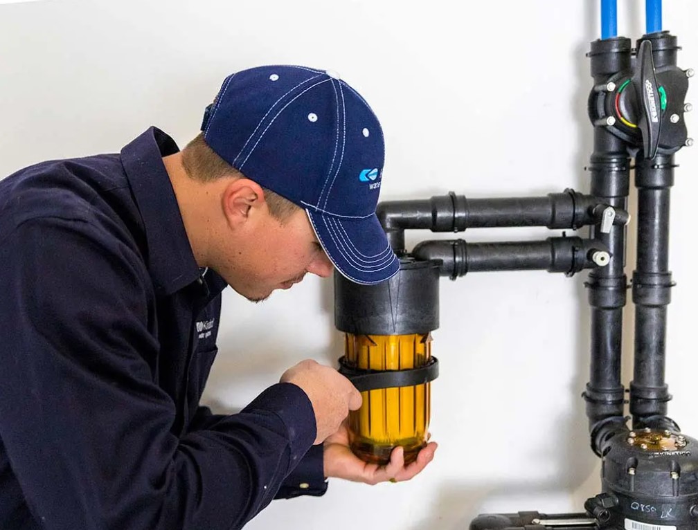 Aqua-Soft technician performing a scheduled water system service